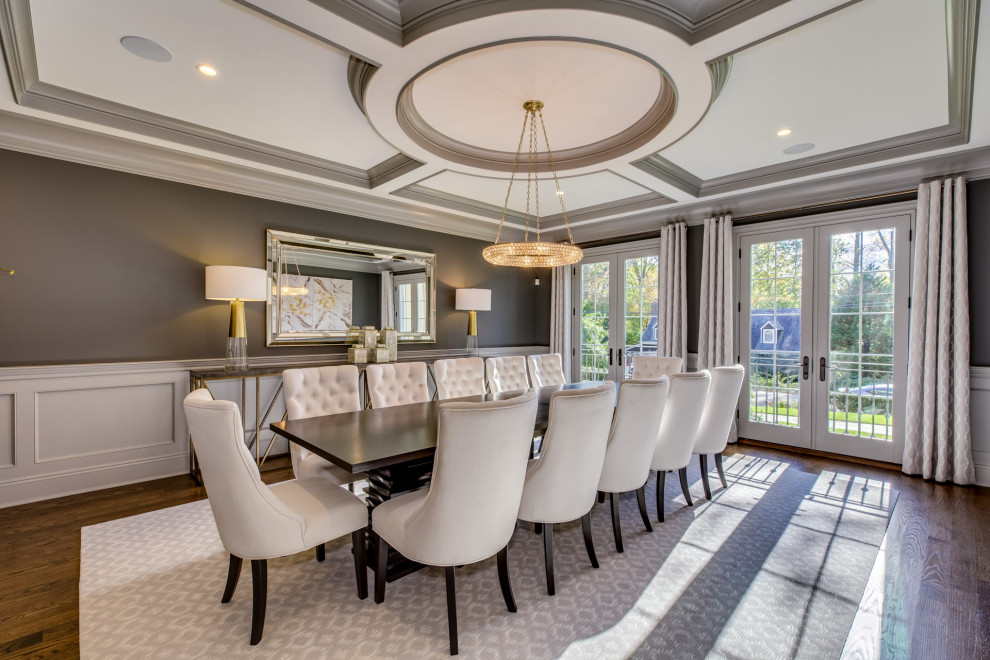 This is an example of a transitional separate dining room in New York with grey walls, medium hardwood floors, no fireplace, brown floor, coffered and panelled walls.