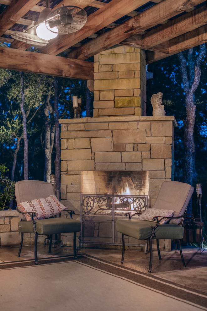 Large modern backyard patio in Austin with a fire feature, concrete pavers and a gazebo/cabana.