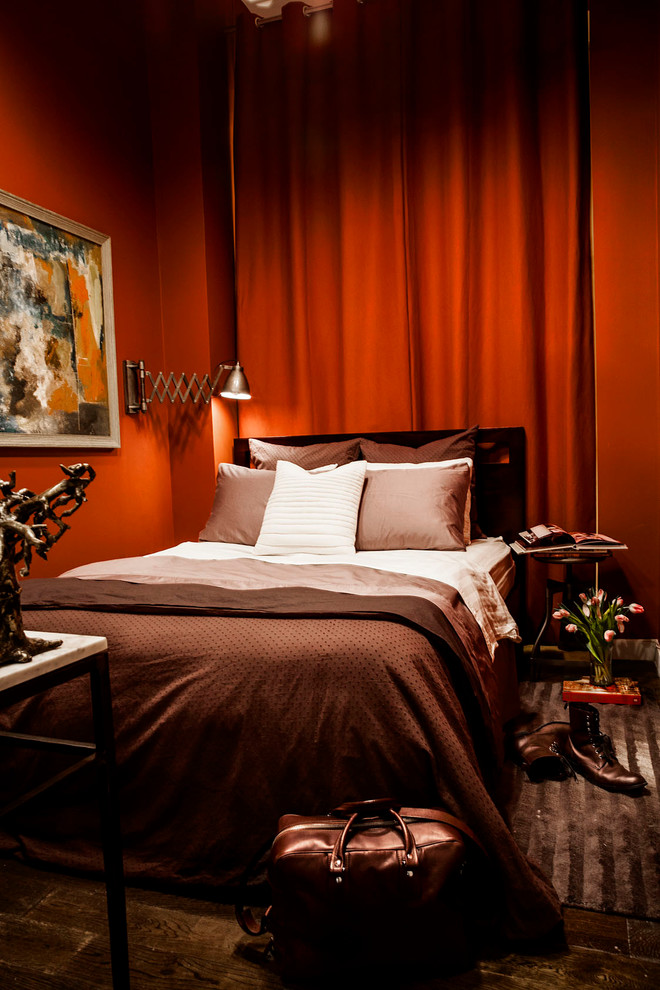 This is an example of a contemporary bedroom in New York with red walls.