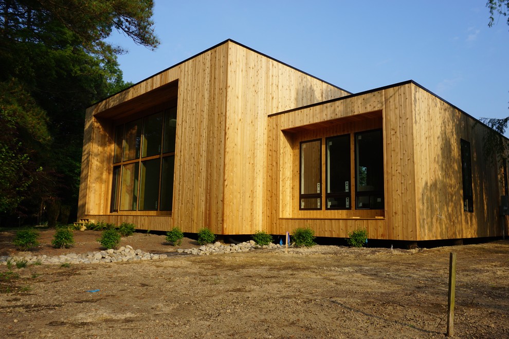 Inspiration for a mid-sized modern one-storey exterior in Other with wood siding.