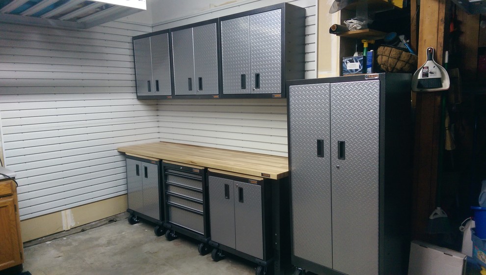 Mid-sized transitional attached two-car garage workshop photo in Denver