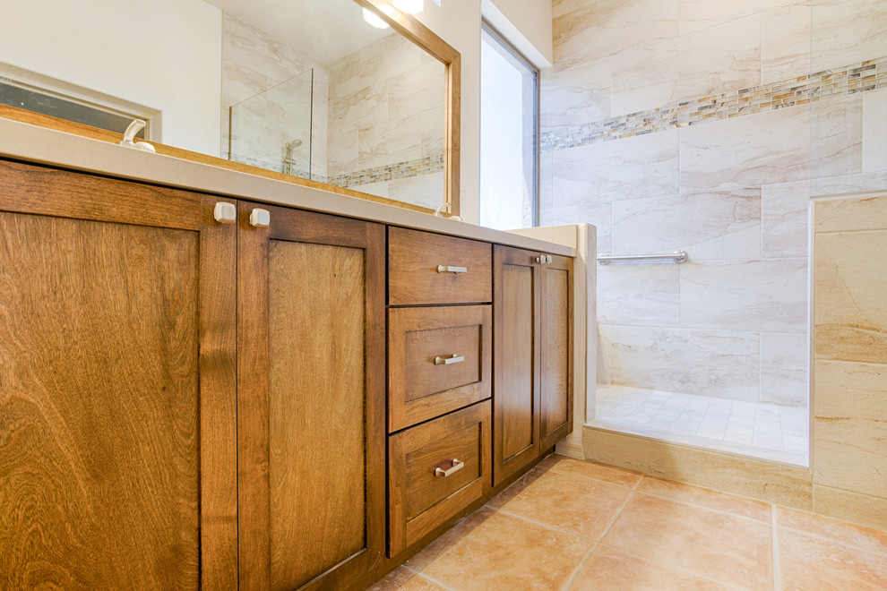 Inspiration for a large transitional master gray tile and porcelain tile doorless shower remodel in Phoenix with recessed-panel cabinets, medium tone wood cabinets, beige walls, an undermount sink and quartzite countertops