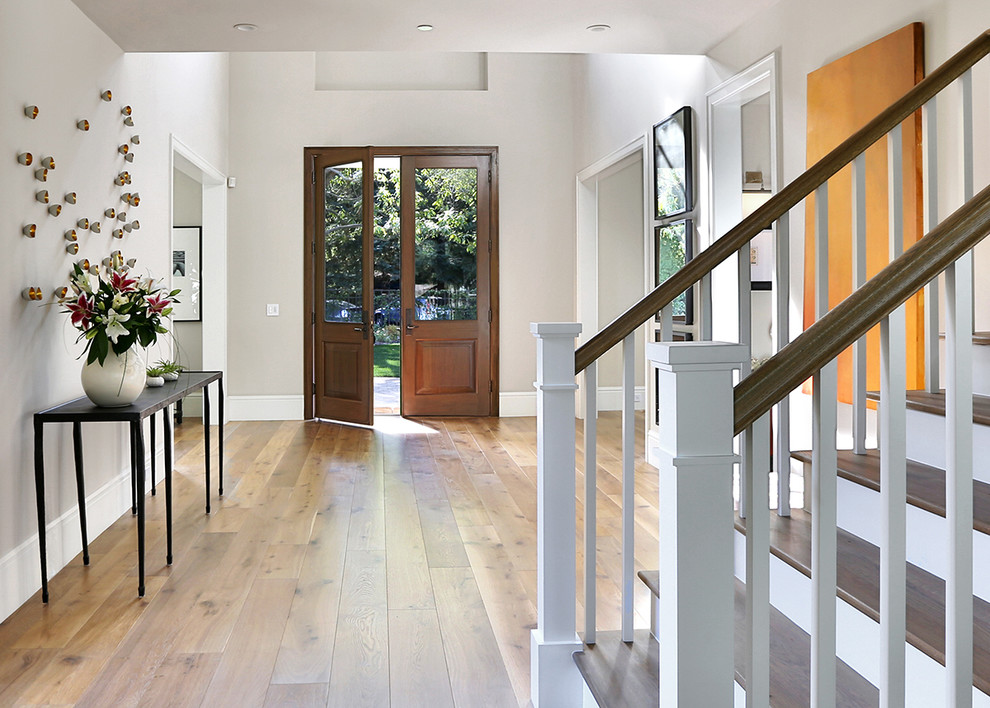 Design ideas for a transitional entryway in San Francisco with a dark wood front door and beige walls.