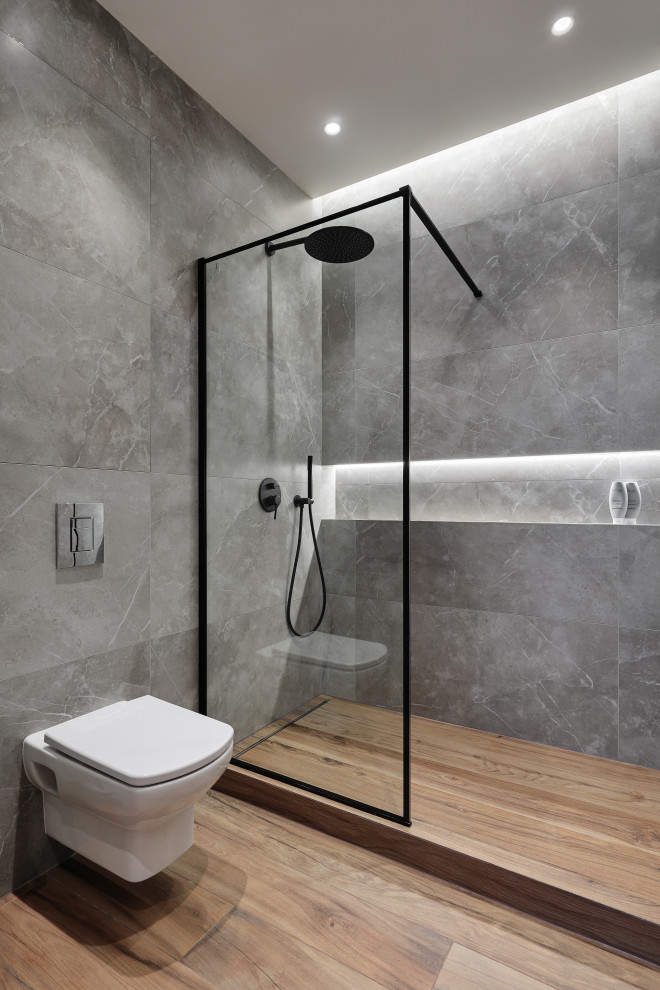 Mid-sized scandinavian master bathroom in Saint Petersburg with flat-panel cabinets, grey cabinets, a freestanding tub, an alcove shower, a wall-mount toilet, gray tile, porcelain tile, grey walls, wood-look tile, wood benchtops, brown floor, a shower curtain, brown benchtops, a single vanity and a freestanding vanity.