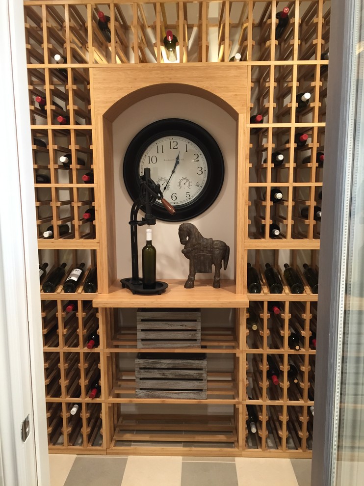 This is an example of a small transitional wine cellar in Los Angeles with ceramic floors and storage racks.