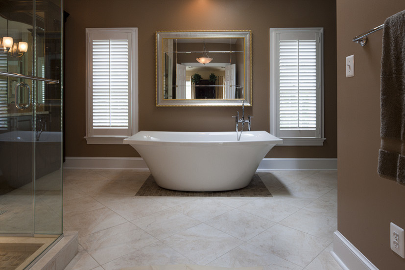 This is an example of a large contemporary master bathroom in DC Metro with a freestanding tub, a corner shower, beige tile, beige walls and ceramic floors.