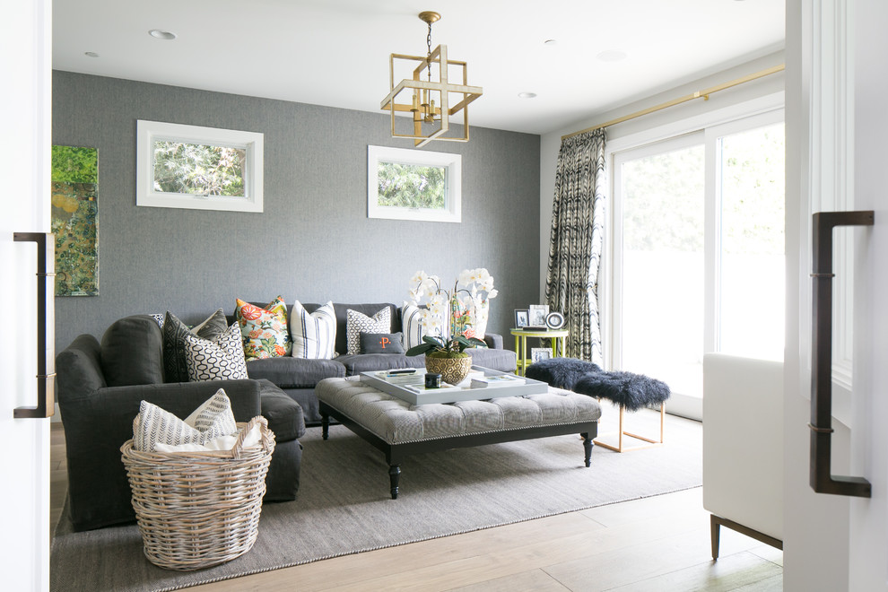 Inspiration for a transitional living room in Orange County with grey walls and light hardwood floors.