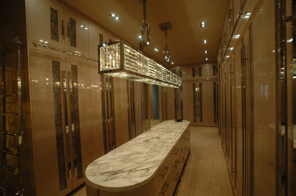 Large transitional women's walk-in wardrobe in Las Vegas with flat-panel cabinets, beige cabinets and carpet.