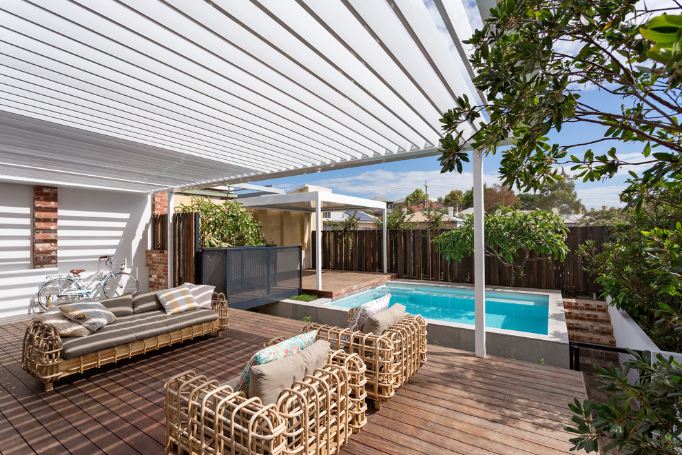 Mid-sized transitional backyard deck in Perth with a pergola.