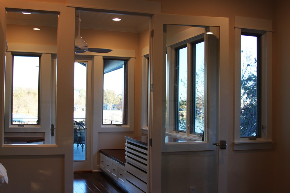 Mid-sized dark wood floor mudroom photo in Austin with beige walls