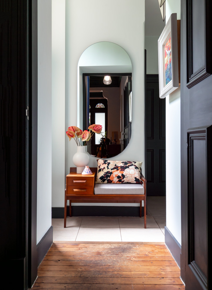 Photo of a large eclectic entry hall in Glasgow with medium hardwood floors and brown floor.