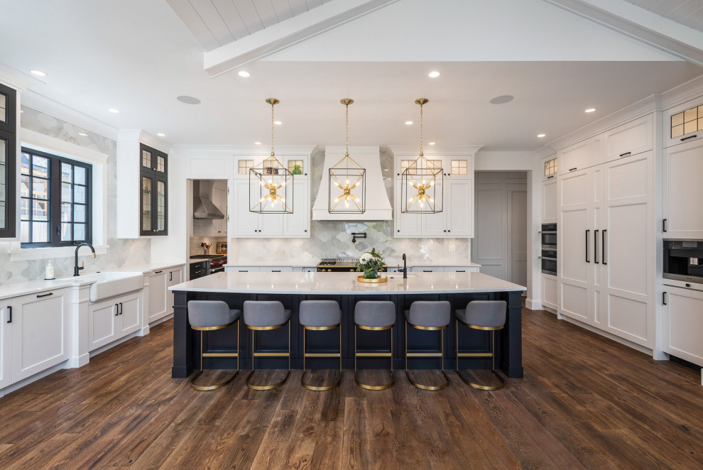Inspiration for a large craftsman dark wood floor, brown floor and shiplap ceiling open concept kitchen remodel in Vancouver with a farmhouse sink, shaker cabinets, white cabinets, quartz countertops, white backsplash, porcelain backsplash, black appliances, an island and white countertops