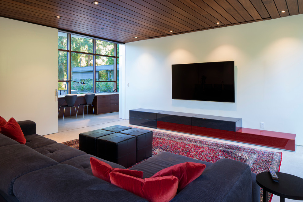 This is an example of a modern enclosed home theatre in Seattle with white walls, porcelain floors and a built-in media wall.