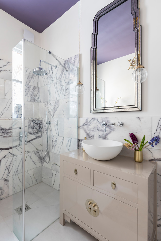 This is an example of a mid-sized contemporary 3/4 wet room bathroom in London with furniture-like cabinets, grey cabinets, a wall-mount toilet, white tile, stone tile, white walls, porcelain floors, a vessel sink and wood benchtops.