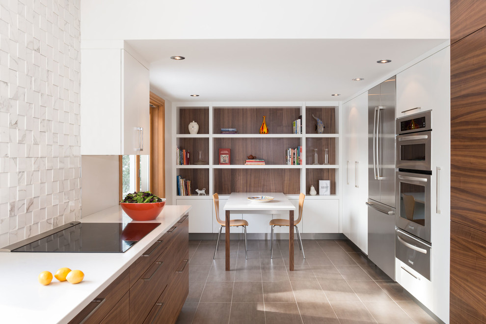 Inspiration for a mid-sized contemporary u-shaped eat-in kitchen in Montreal with a double-bowl sink, flat-panel cabinets, medium wood cabinets, quartz benchtops, white splashback, stone tile splashback, stainless steel appliances, porcelain floors and with island.