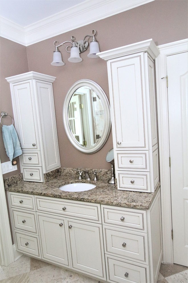 Photo of a mid-sized traditional master bathroom in Atlanta with beige cabinets, a freestanding tub, an open shower, beige tile, travertine, brown walls, travertine floors, a drop-in sink, granite benchtops, beige floor and brown benchtops.