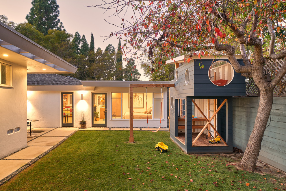 This is an example of a small midcentury two-storey blue exterior in San Diego with wood siding, a shed roof, a metal roof and clapboard siding.