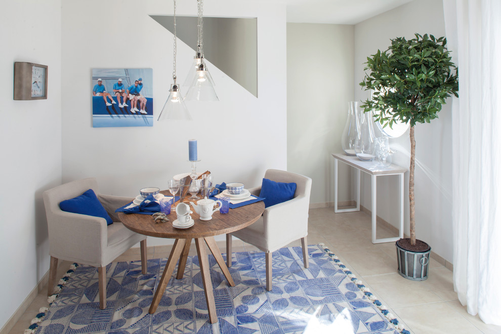 This is an example of a beach style dining room in Other with white walls and no fireplace.