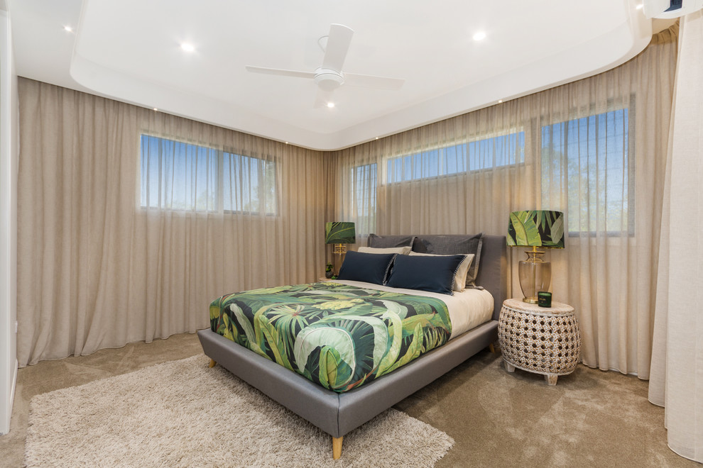Photo of a large modern master bedroom in Townsville with beige walls, carpet and brown floor.