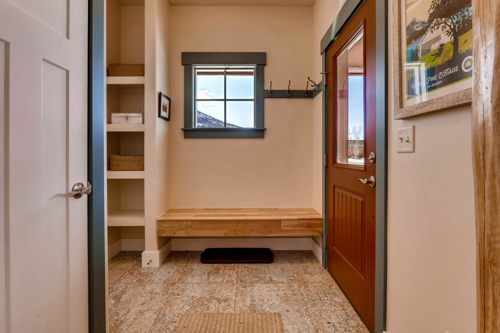 Inspiration for a small eclectic ceramic tile and blue floor mudroom remodel in Denver with beige walls and a red front door