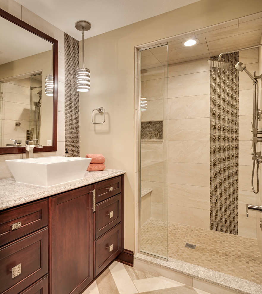 Photo of a mid-sized traditional 3/4 bathroom in Minneapolis with a vessel sink, recessed-panel cabinets, dark wood cabinets, an alcove shower, beige tile, beige walls and beige floor.