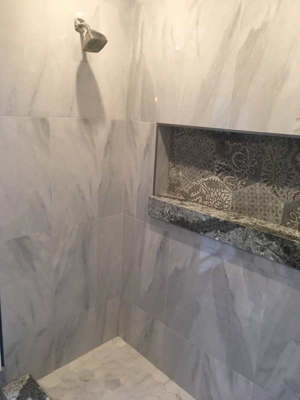 This is an example of a mid-sized contemporary master bathroom in Miami with shaker cabinets, white cabinets, an alcove shower, gray tile, porcelain tile, blue walls, porcelain floors, engineered quartz benchtops, grey floor and a hinged shower door.