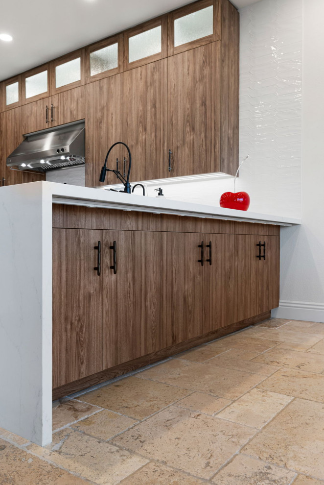 Mountain style l-shaped slate floor and beige floor enclosed kitchen photo with a single-bowl sink, flat-panel cabinets, medium tone wood cabinets, quartzite countertops, white backsplash, glass sheet backsplash, stainless steel appliances, a peninsula and white countertops