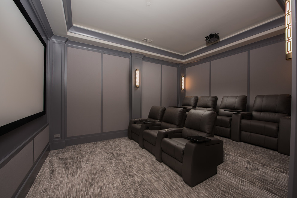 Large transitional enclosed home theatre in Chicago with grey walls, carpet, a projector screen and grey floor.