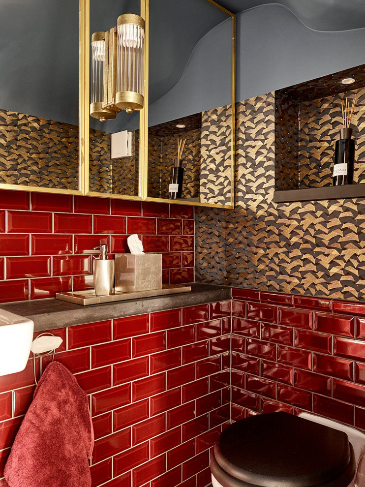Photo of a contemporary powder room in Other with a wall-mount toilet, red tile, subway tile, multi-coloured walls, a wall-mount sink and brown benchtops.