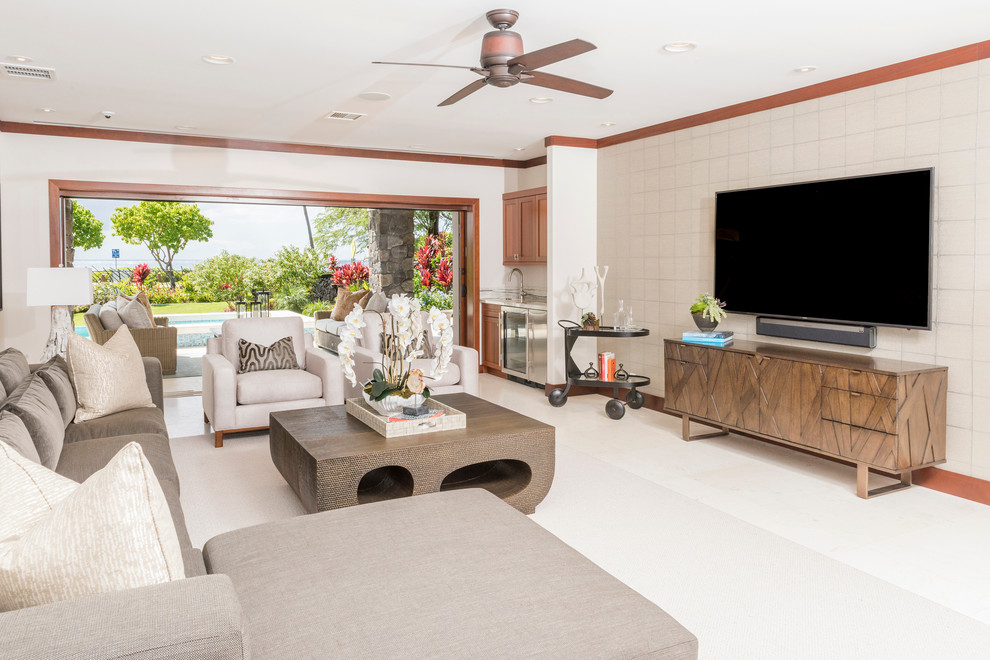 Inspiration for a large transitional open concept family room in Hawaii with a wall-mounted tv, beige walls, porcelain floors and no fireplace.