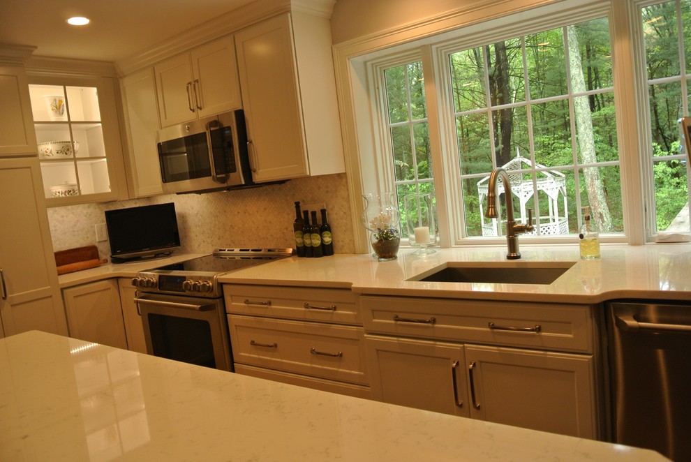 Transitional medium tone wood floor eat-in kitchen photo in Boston with an undermount sink, shaker cabinets, quartz countertops, beige backsplash, mosaic tile backsplash, stainless steel appliances, an island and white countertops