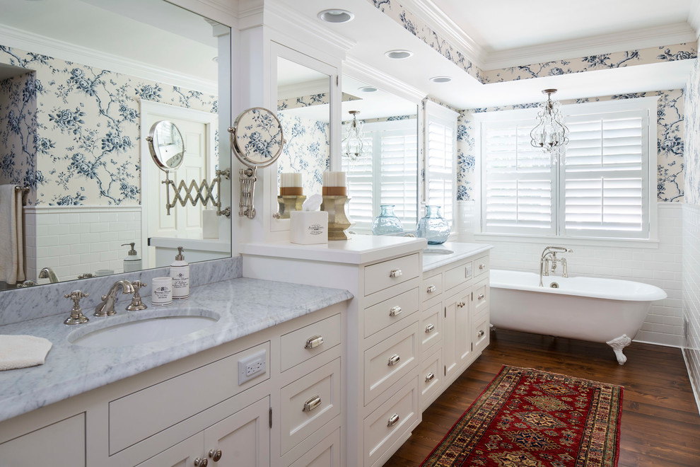Beach style bathroom in Minneapolis with an undermount sink, recessed-panel cabinets, white cabinets, a claw-foot tub, white tile, subway tile, multi-coloured walls and dark hardwood floors.