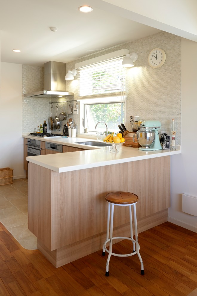Contemporary l-shaped open plan kitchen in Other with a single-bowl sink, flat-panel cabinets, light wood cabinets, painted wood floors and brown floor.