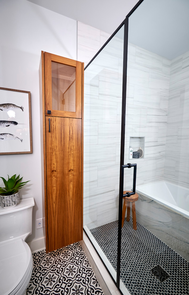 Photo of a mid-sized midcentury master wet room bathroom in Denver with flat-panel cabinets, medium wood cabinets, an alcove tub, a one-piece toilet, black and white tile, porcelain tile, white walls, cement tiles, a vessel sink, quartzite benchtops, black floor, a hinged shower door, white benchtops, a niche, a double vanity, a floating vanity and planked wall panelling.