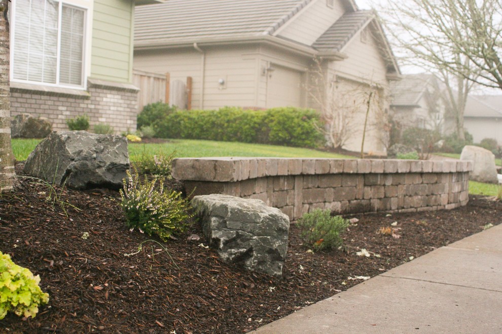 Photo of a mid-sized arts and crafts front yard garden for winter in Other with a retaining wall.