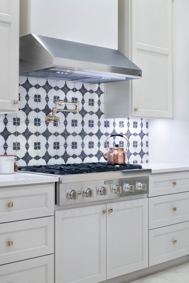 Large country galley eat-in kitchen in Austin with a farmhouse sink, recessed-panel cabinets, grey cabinets, marble benchtops, blue splashback, marble splashback, coloured appliances, light hardwood floors, with island, brown floor, white benchtop and recessed.