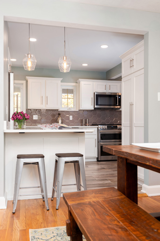 Inspiration for a small transitional u-shaped porcelain tile and beige floor kitchen pantry remodel with an undermount sink, recessed-panel cabinets, white cabinets, quartz countertops, beige backsplash, ceramic backsplash, stainless steel appliances and white countertops