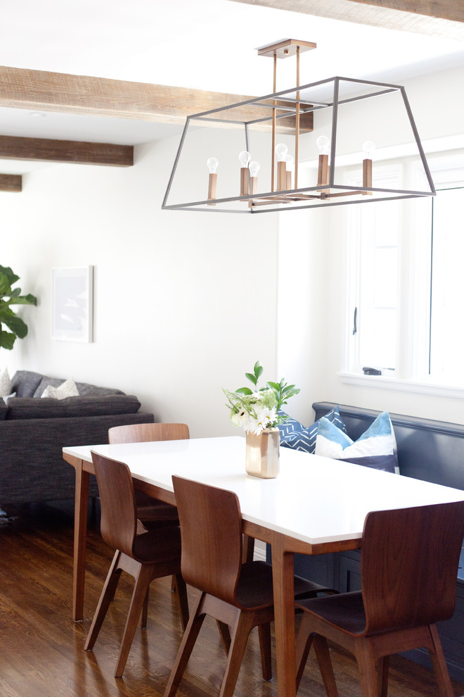 This is an example of a mid-sized transitional kitchen/dining combo in Los Angeles with dark hardwood floors, brown floor and white walls.