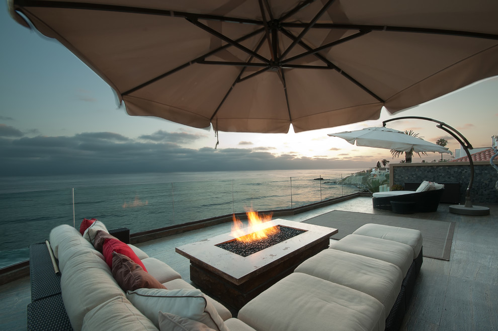 This is an example of a mid-sized contemporary rooftop and rooftop deck in San Diego with a fire feature and no cover.