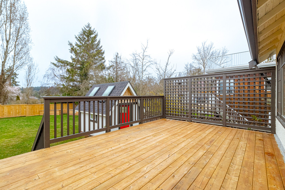 Mid-sized transitional backyard second story privacy and wood railing deck photo