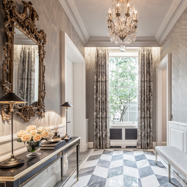 Mid-sized traditional hallway in London with grey walls and marble floors.