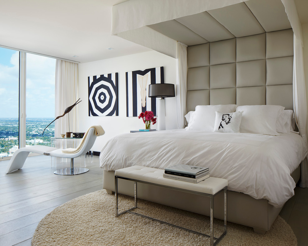 Design ideas for a large contemporary guest bedroom in Miami with white walls and light hardwood floors.