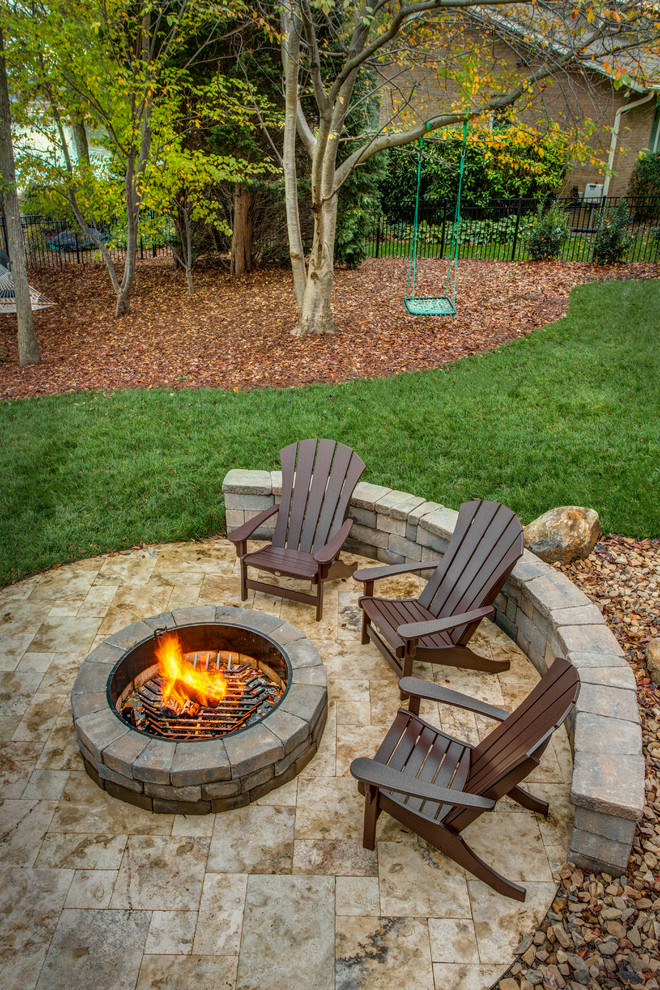 Example of a large mountain style backyard tile patio design in Charlotte with a fire pit and no cover