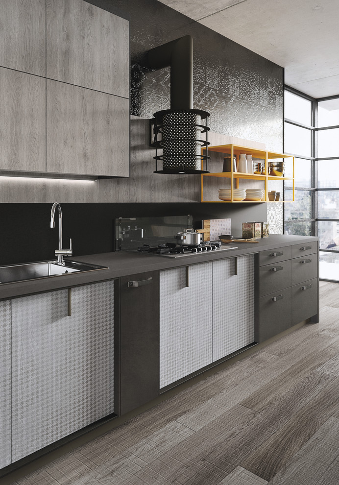 Inspiration for a mid-sized industrial l-shaped open plan kitchen in Marseille with an integrated sink, glass-front cabinets, light wood cabinets, concrete benchtops, grey splashback, cement tile splashback, black appliances, painted wood floors and with island.