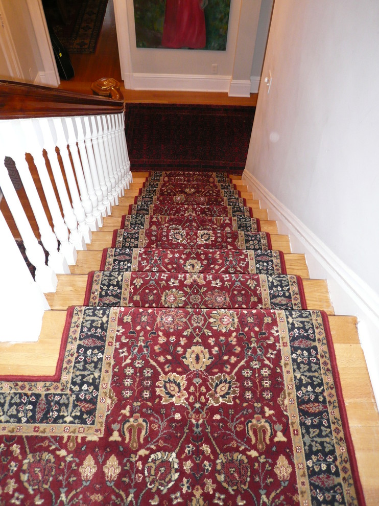 This is an example of a mid-sized traditional wood straight staircase in Ottawa with painted wood risers.