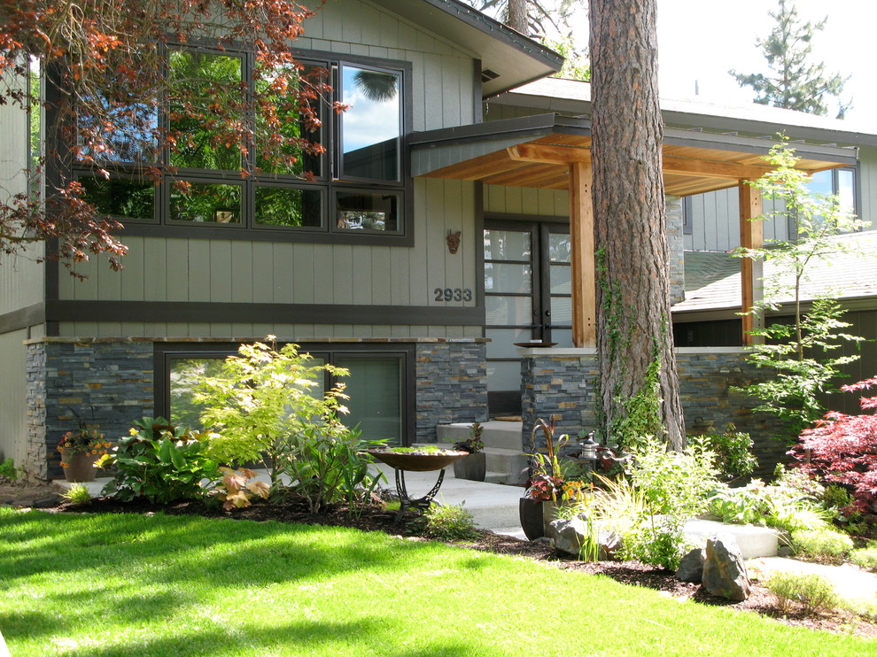 Mid-sized transitional two-storey green exterior in Seattle with mixed siding and a gable roof.