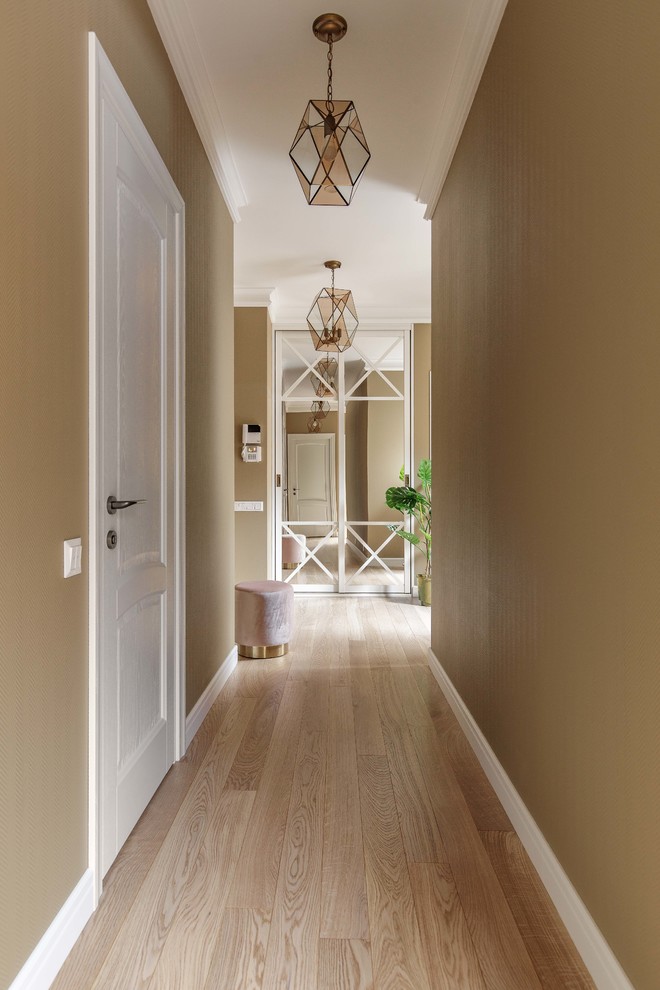 Design ideas for a mid-sized transitional hallway in Moscow with beige walls, medium hardwood floors and beige floor.