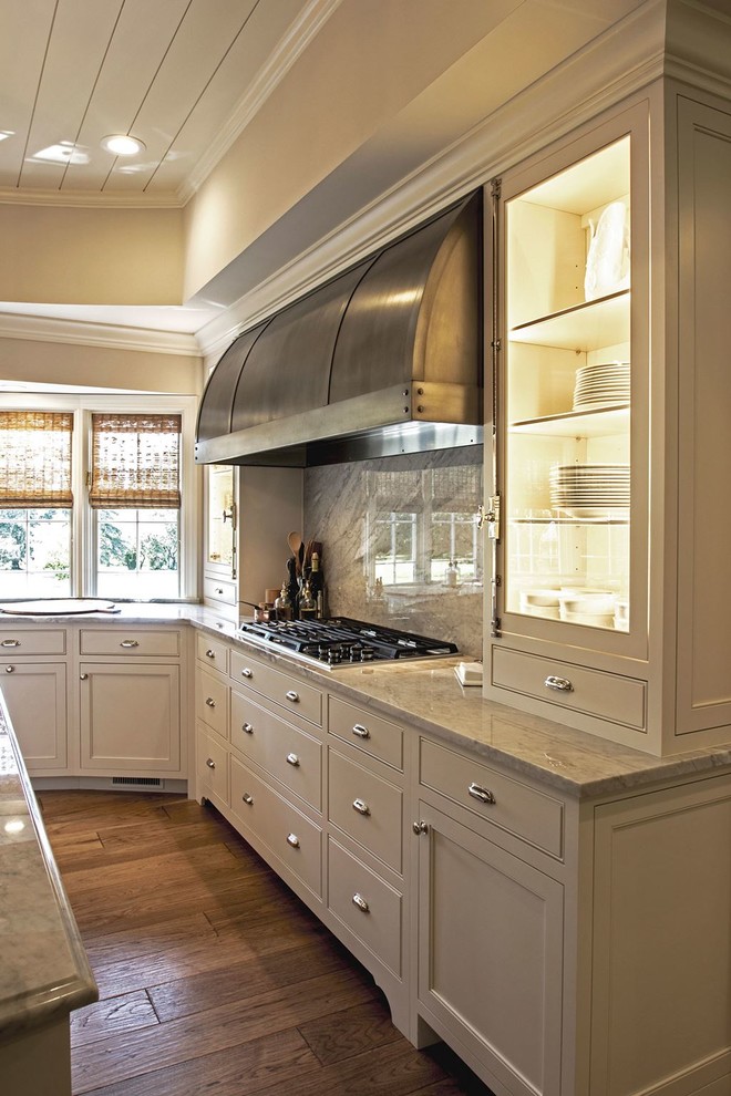Example of a large transitional l-shaped medium tone wood floor open concept kitchen design in Austin with a farmhouse sink, shaker cabinets, white cabinets, marble countertops, multicolored backsplash, stone slab backsplash, stainless steel appliances and an island