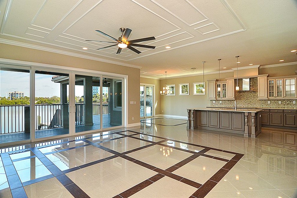 Large transitional open concept family room in Tampa with beige walls, porcelain floors and no fireplace.