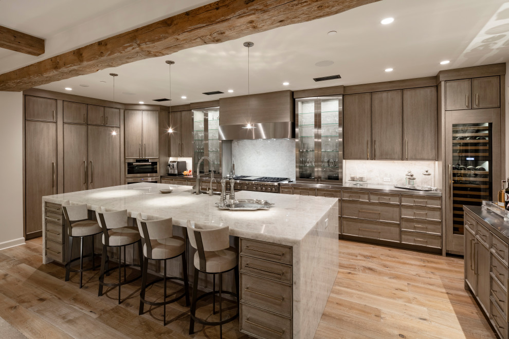 Inspiration for a contemporary u-shaped kitchen in Phoenix with a farmhouse sink, recessed-panel cabinets, medium wood cabinets, white splashback, stainless steel appliances, light hardwood floors, with island, beige floor and white benchtop.